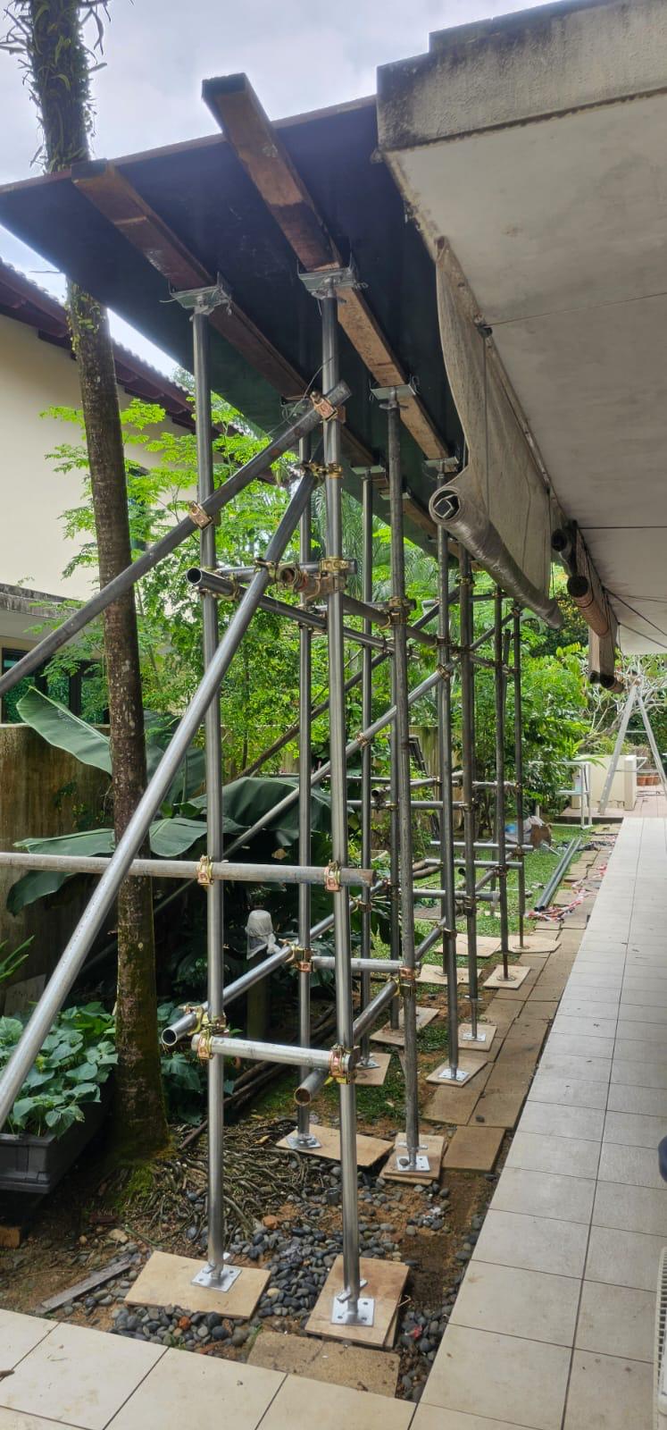 Mobile aluminium scaffold tower positioned against the Ewart Park bungalow second unit facade for safe work-at-height access to the roofline