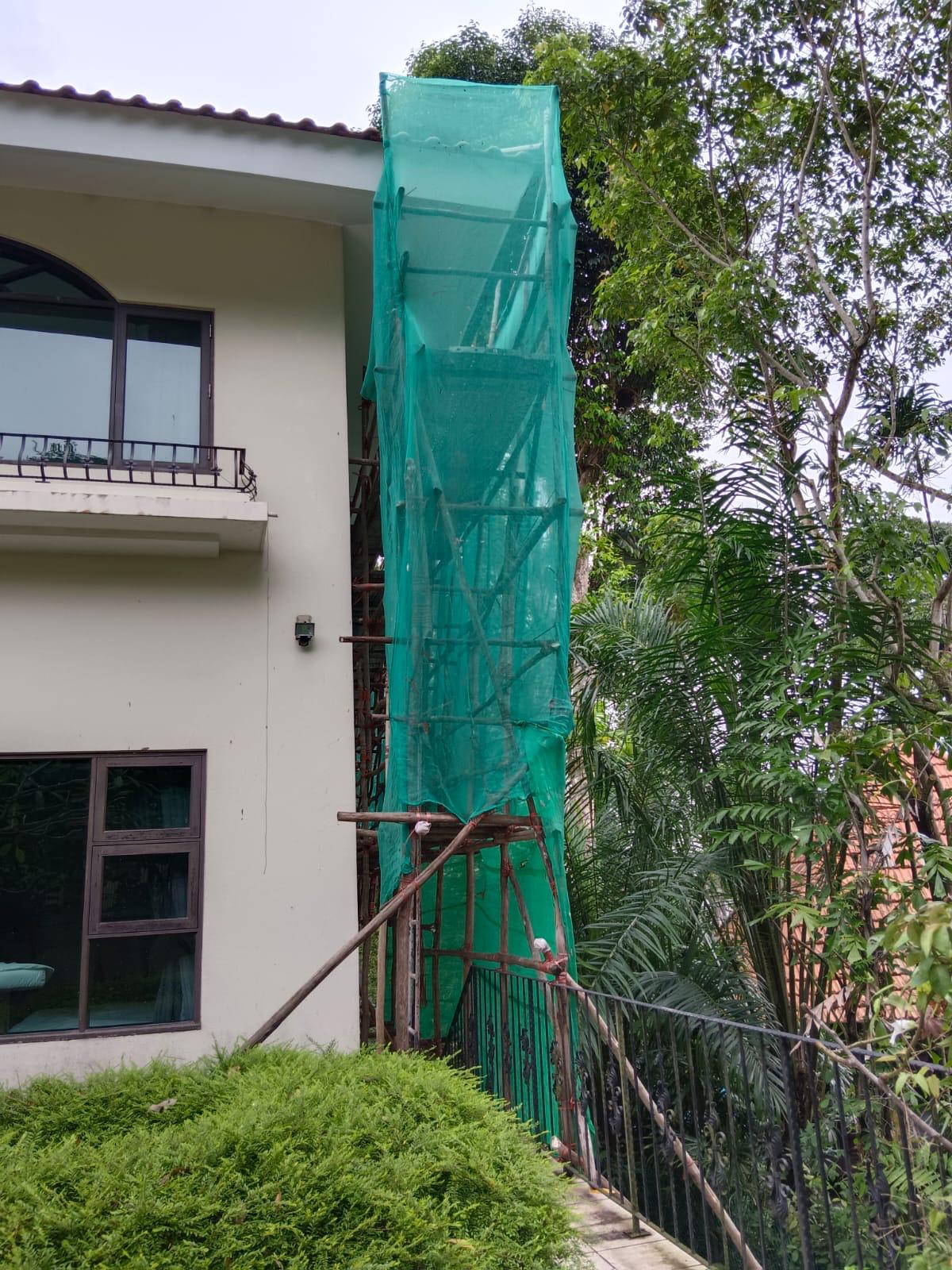 Mobile aluminium scaffold tower positioned beside the Ewart Park bungalow facade for safe work-at-height access to the roofline