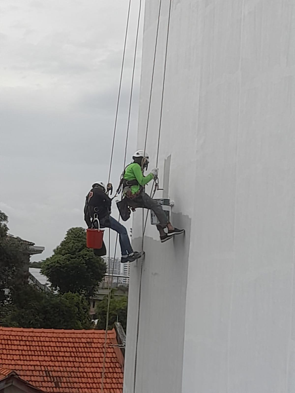 Rope access work positioning on a high-rise residential facade during a waterproofing and concrete repair campaign