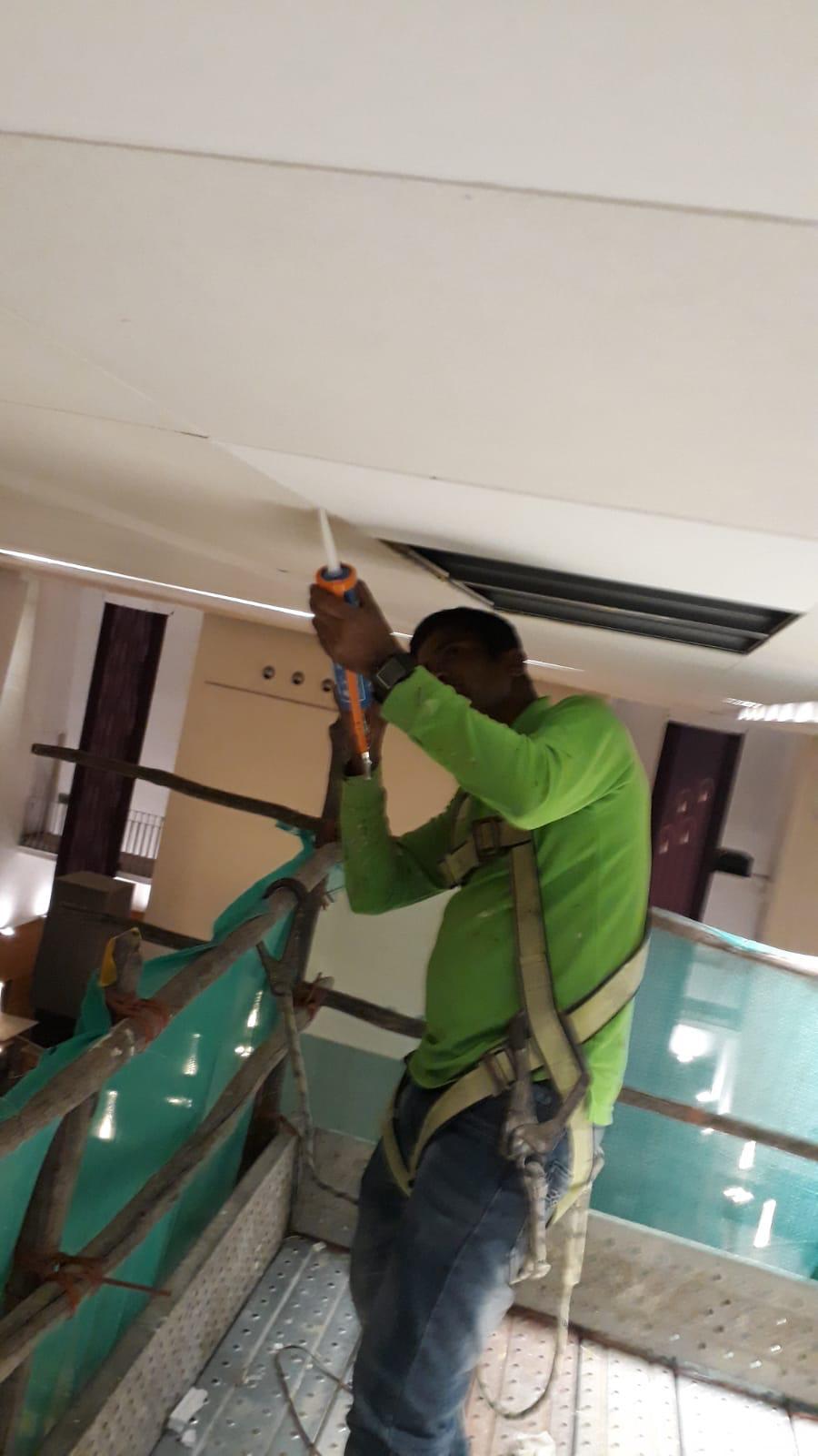 Detail view at high level of the water-damaged ceiling board area being prepared for replacement at the St Mary of the Angels Church