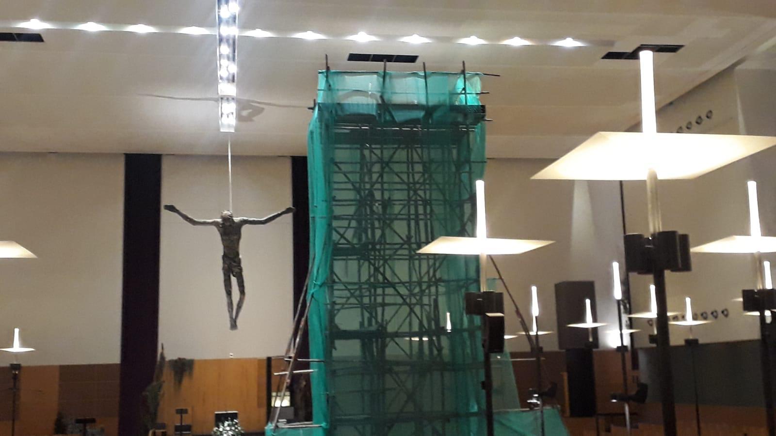Wide view of the St Mary of the Angels Church nave with the 12m timber scaffold tower in place and worship furniture protected at the perimeter