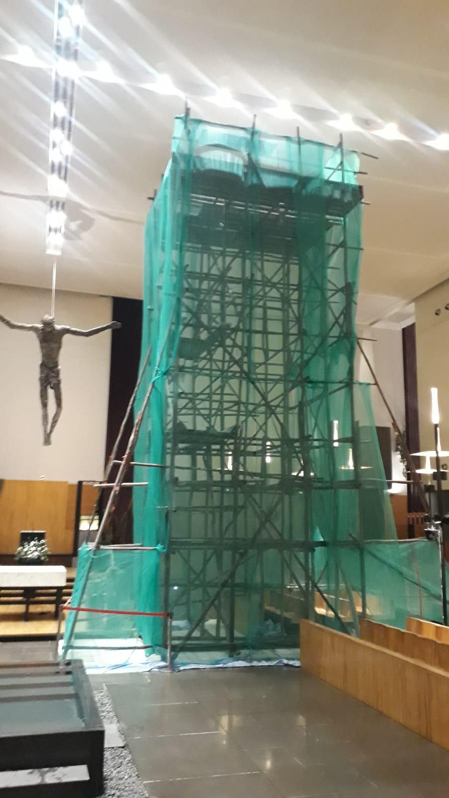 Working platform tier of the internal timber scaffold inside the St Mary of the Angels Church showing the deck against the high ceiling
