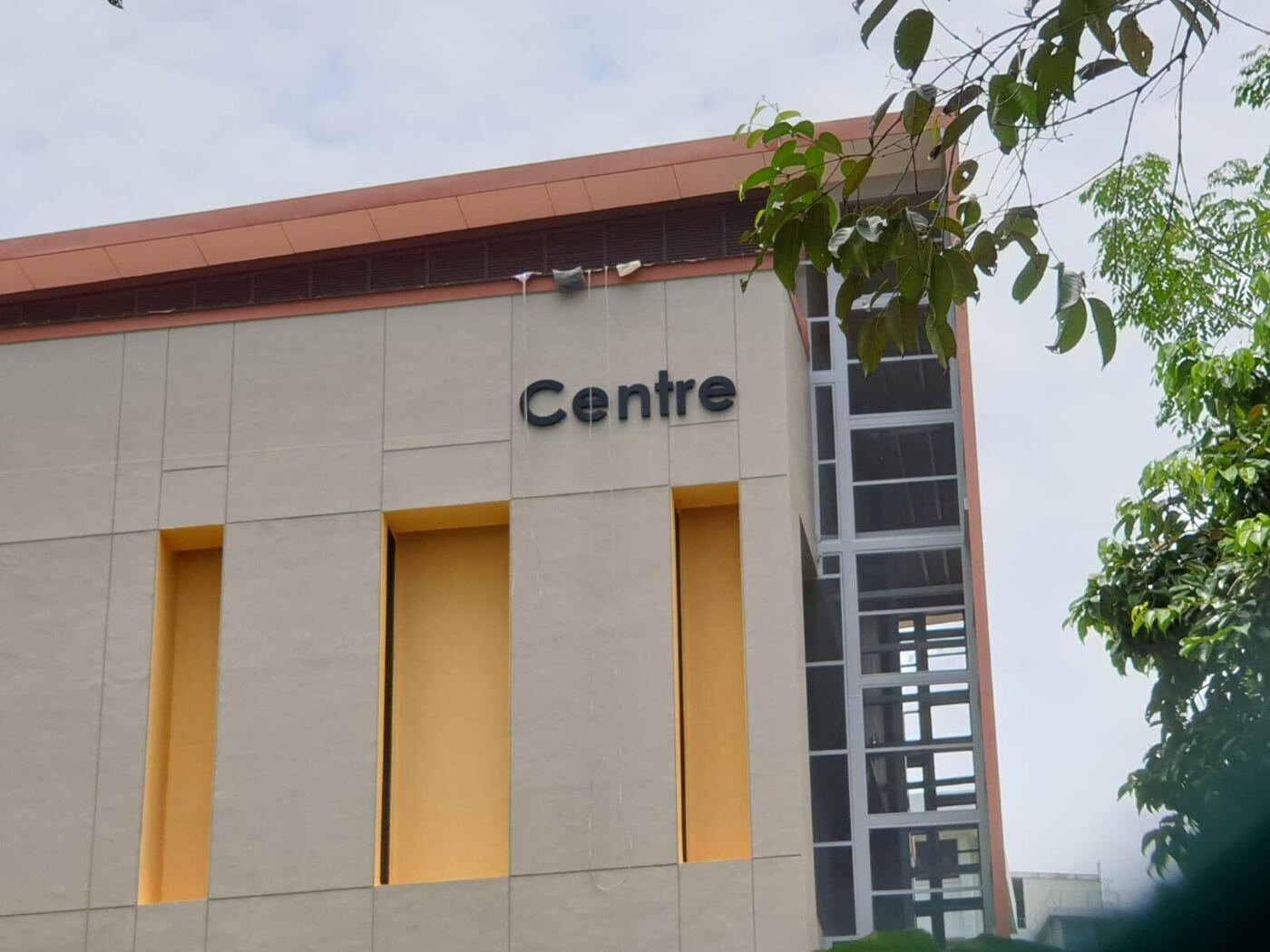 Boomlift positioned beside a building for signage installation in Singapore