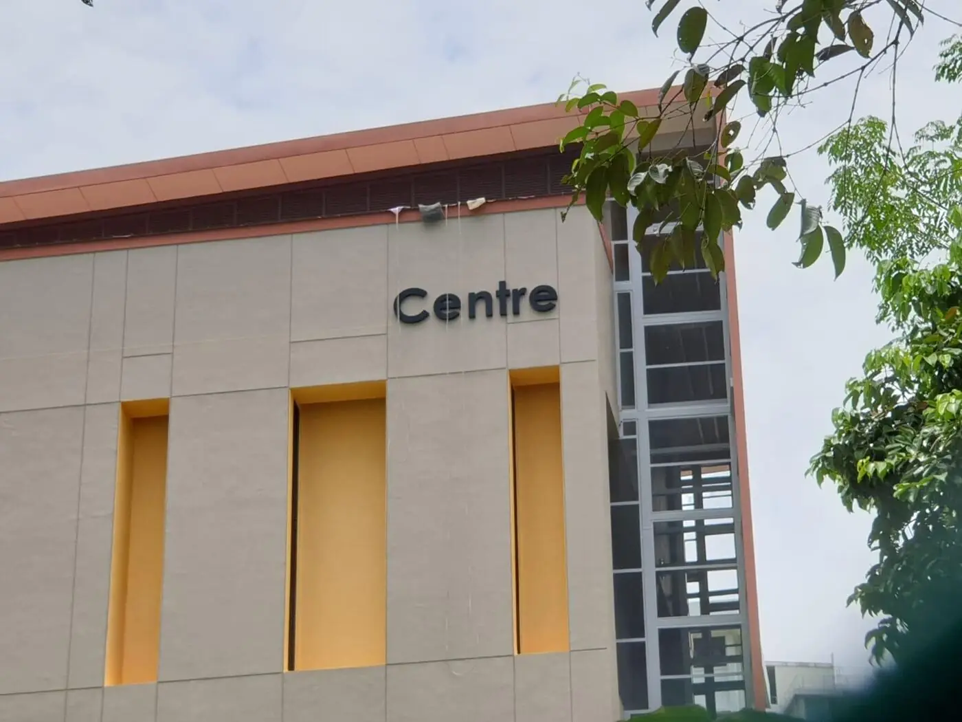 Boomlift positioned beside a building for signage installation in Singapore